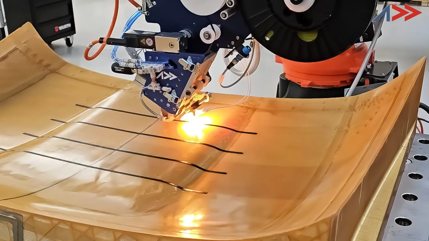 Laser-assisted thermoplastic fiber placement on a curved structural tool