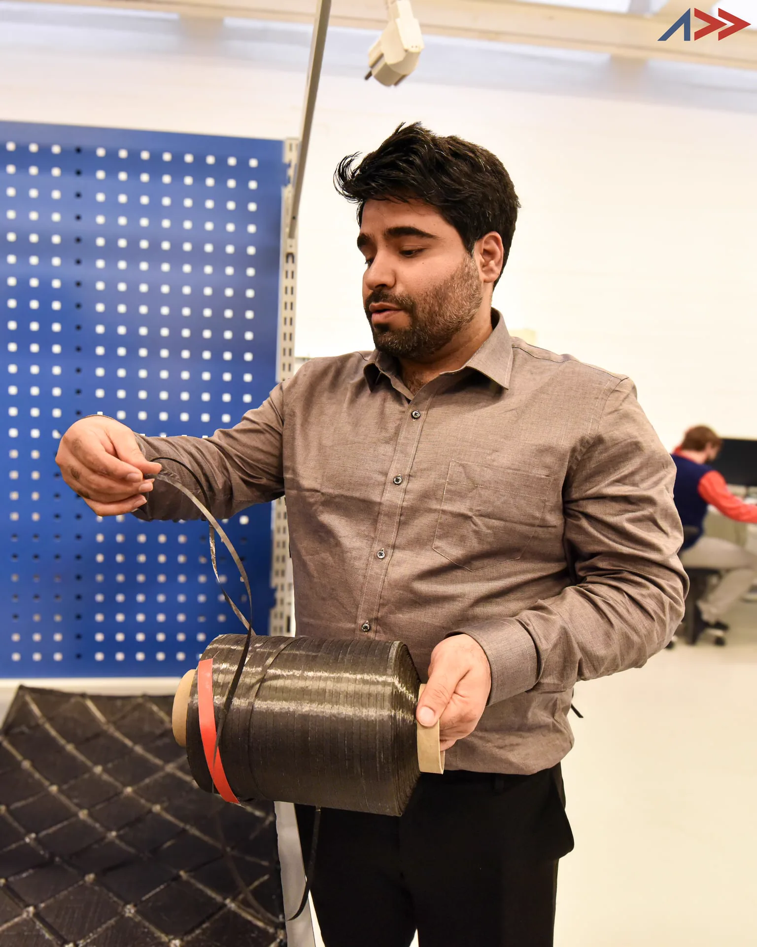 Pravin Luthada presenting a dry-fiber composite demonstrator