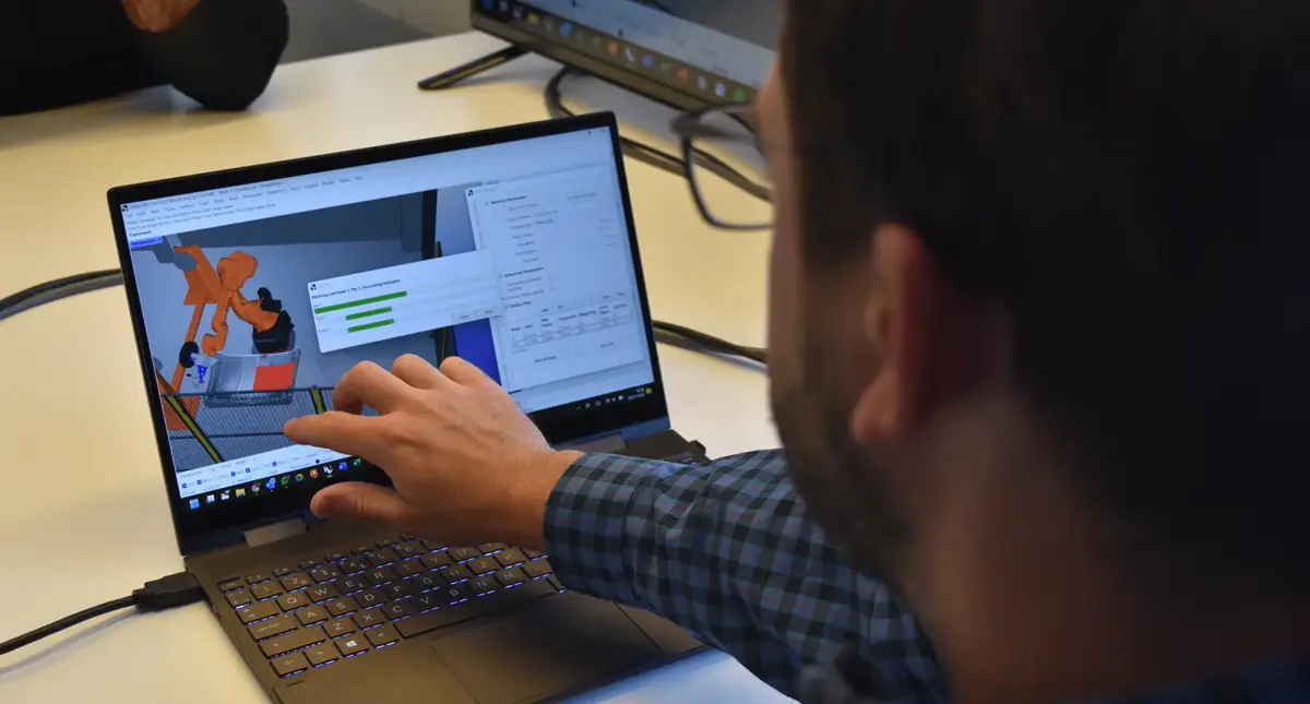 Engineer reviewing a robotic production plan in AddPath